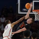
              Miami's Sam Waardenburg (21) blocks Auburn's Jabari Smith (10) during the second half of a college basketball game in the second round of the NCAA tournament Sunday, March 20, 2022, in Greenville, S.C. (AP Photo/Brynn Anderson)
            