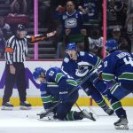 
              Vancouver Canucks' Bo Horvat (53), J.T. Miller (9) and Quinn Hughes (43) celebrate a goal by Horvat against the Washington Capitals during the third period of an NHL hockey game Friday, March 11, 2022, in Vancouver, British Columbia. (Darryl Dyck/The Canadian Press via AP)
            