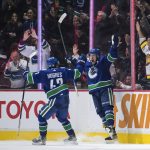 
              Vancouver Canucks' Bo Horvat, right, and Quinn Hughes celebrate Horvat's second goal against the Washington Capitals, during the third period of an NHL hockey game Friday, March 11, 2022, in Vancouver, British Columbia. (Darryl Dyck/The Canadian Press via AP)
            