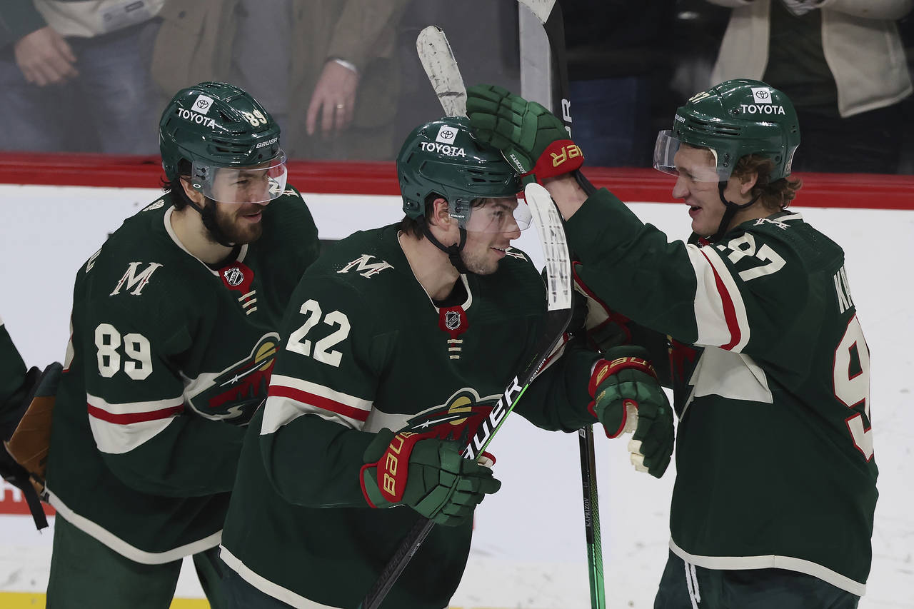 Minnesota Wild left wing Kevin Fiala (22) celebrates with left wing Kirill Kaprizov (97) after Fial...