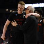 
              Miami head coach Jim Larranaga, front right, talks to Sam Waardenburg (21) after a win over Auburn in a college basketball game in the second round of the NCAA tournament, Sunday, March 20, 2022, in Greenville, S.C. (AP Photo/Brynn Anderson)
            