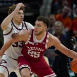
              Indiana forward Race Thompson (25) drives on Illinois forward Coleman Hawkins (33) in the first half of an NCAA college basketball game at the Big Ten Conference tournament in Indianapolis, Friday, March 11, 2022. (AP Photo/Michael Conroy)
            