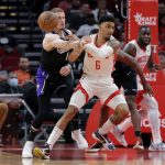 
              Sacramento Kings guard Donte DiVincenzo, left, knocks the ball away from Houston Rockets forward Kenyon Martin Jr. (6) during the first half of an NBA basketball game Wednesday, March 30, 2022, in Houston. (AP Photo/Michael Wyke)
            