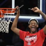 
              Arizona guard Dalen Terry (4) celebrates while cutting the net after an NCAA college basketball game against California, Saturday, March 5, 2022, in Tucson, Ariz. Arizona won the Pac-12 Conference Championship. (AP Photo/Rick Scuteri)
            