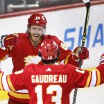 
              Calgary Flames left wing Johnny Gaudreau (13) celebrates his hat-trick goal against the Tampa Bay Lightning with Elias Lindholm during the third period of an NHL hockey game Thursday, March 10, 2022, in Calgary, Alberta. (Larry MacDougal/The Canadian Press via AP)
            