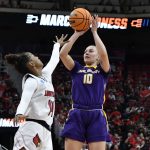 
              Albany guard Ellen Hahne (10) shoots over Louisville guard Kianna Smith (14) during the first half of their women's NCAA Tournament college basketball first round game in Louisville, Ky., Friday, March 18, 2022. (AP Photo/Timothy D. Easley)
            