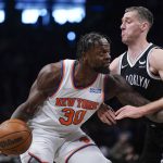 
              New York Knicks' Julius Randle, left, looks past Brooklyn Nets' Goran Dragic during the first half of the NBA basketball game at the Barclays Center, Sunday, Mar. 13, 2022, in New York. (AP Photo/Seth Wenig)
            
