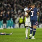 
              Real Madrid's David Alaba hugs PSG's Kylian Mbappe, right, after PSG's loss in the Champions League, round of 16, second leg soccer match between Real Madrid and Paris Saint-Germain at the Santiago Bernabeu stadium in Madrid, Spain, Wednesday, March 9, 2022. (AP Photo/Manu Fernandez)
            