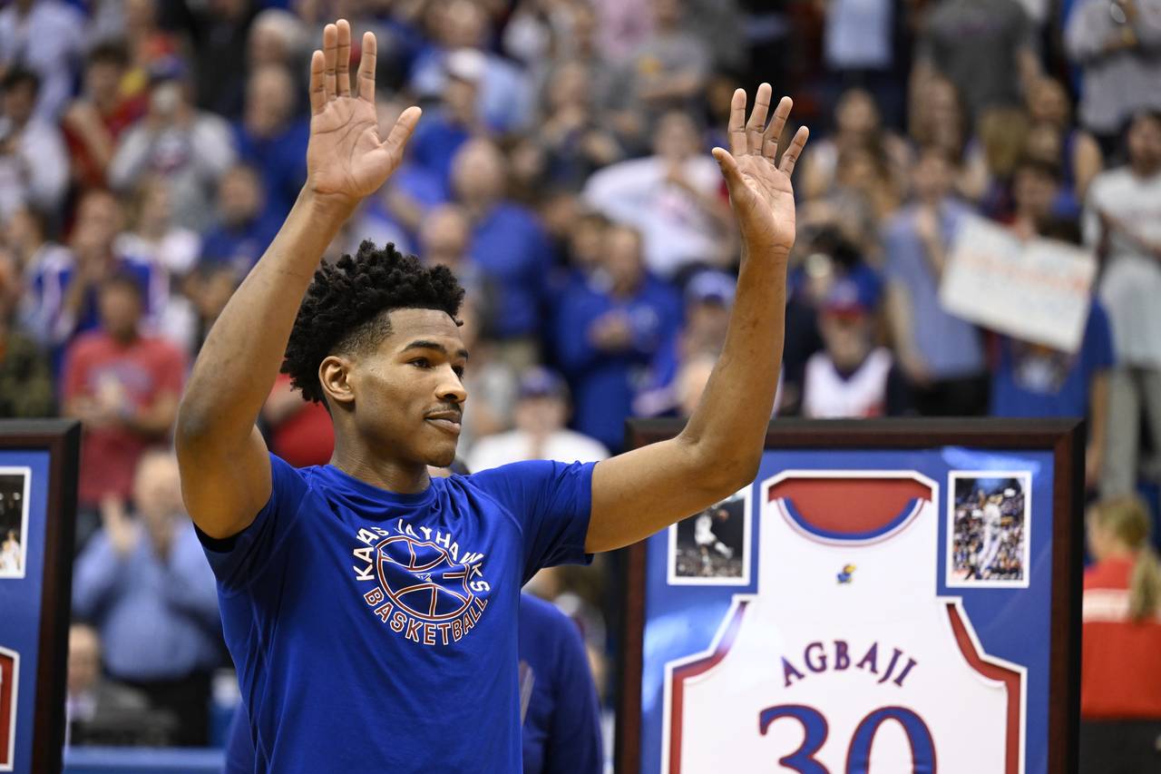 FILE - Kansas guard Ochai Agbaji acknowledges the cheers from the crowd during Senior Day honors be...