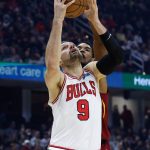 
              Chicago Bulls' Nikola Vucevic (9) shoots against Cleveland Cavaliers' Evan Mobley during the first half of an NBA basketball game Saturday, March 26, 2022, in Cleveland. (AP Photo/Ron Schwane)
            