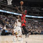 
              Toronto Raptors forward Pascal Siakam, right, goes up for a basket over Denver Nuggets guard Davon Reed in the first half of an NBA basketball game Saturday, March 12, 2022, in Denver. (AP Photo/David Zalubowski)
            