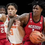 
              North Carolina State's Dereon Seabron (1) collides with Clemson Tigers' David Collins (13) on a drive during the first half of an NCAA college basketball game of the Atlantic Coast Conference men's tournament, Tuesday, March 8, 2022, in New York. (AP Photo/John Minchillo)
            