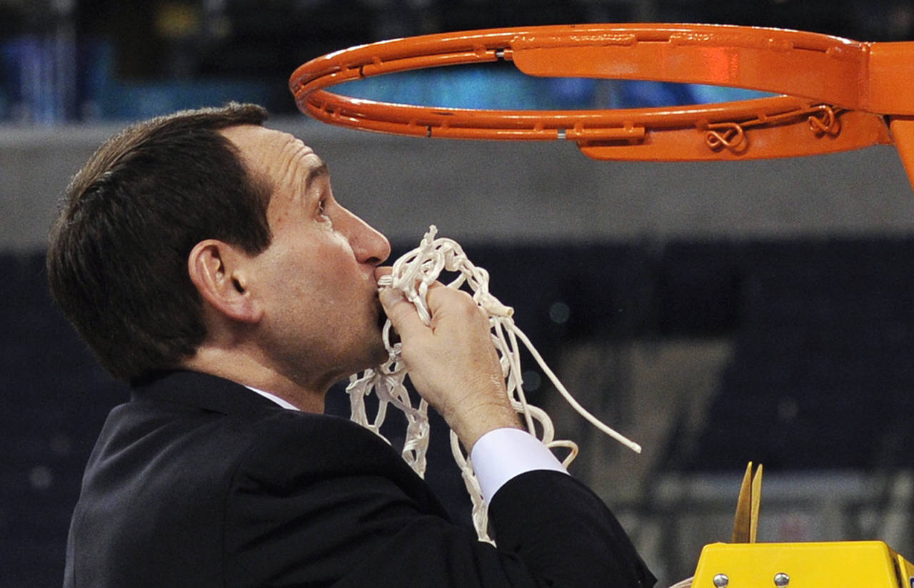 FILE - Duke head coach Mike Krzyzewski kisses the net after cutting it down following Duke's 61-59 ...