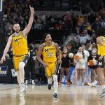 
              Michigan's Hunter Dickinson (1), Eli Brooks (55) and Frankie Collins (10) celebrate after they defeated Tennessee in a college basketball game in the second round of the NCAA tournament, Saturday, March 19, 2022, in Indianapolis. (AP Photo/Darron Cummings)
            