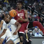 
              UCLA's Cody Riley, left, and Washington State's Efe Abogidi battle for the ball during the first half of an NCAA college basketball game in the quarterfinal round of the Pac-12 tournament Thursday, March 10, 2022, in Las Vegas. (AP Photo/John Locher)
            