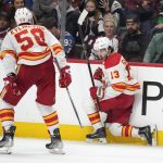 
              Calgary Flames left wing Johnny Gaudreau, right, celebrates his overtime goal against the Colorado Avalanche, next to defenseman Oliver Kylington during an NHL hockey game Saturday, March 5, 2022, in Denver. Calgary won 4-3. (AP Photo/David Zalubowski)
            