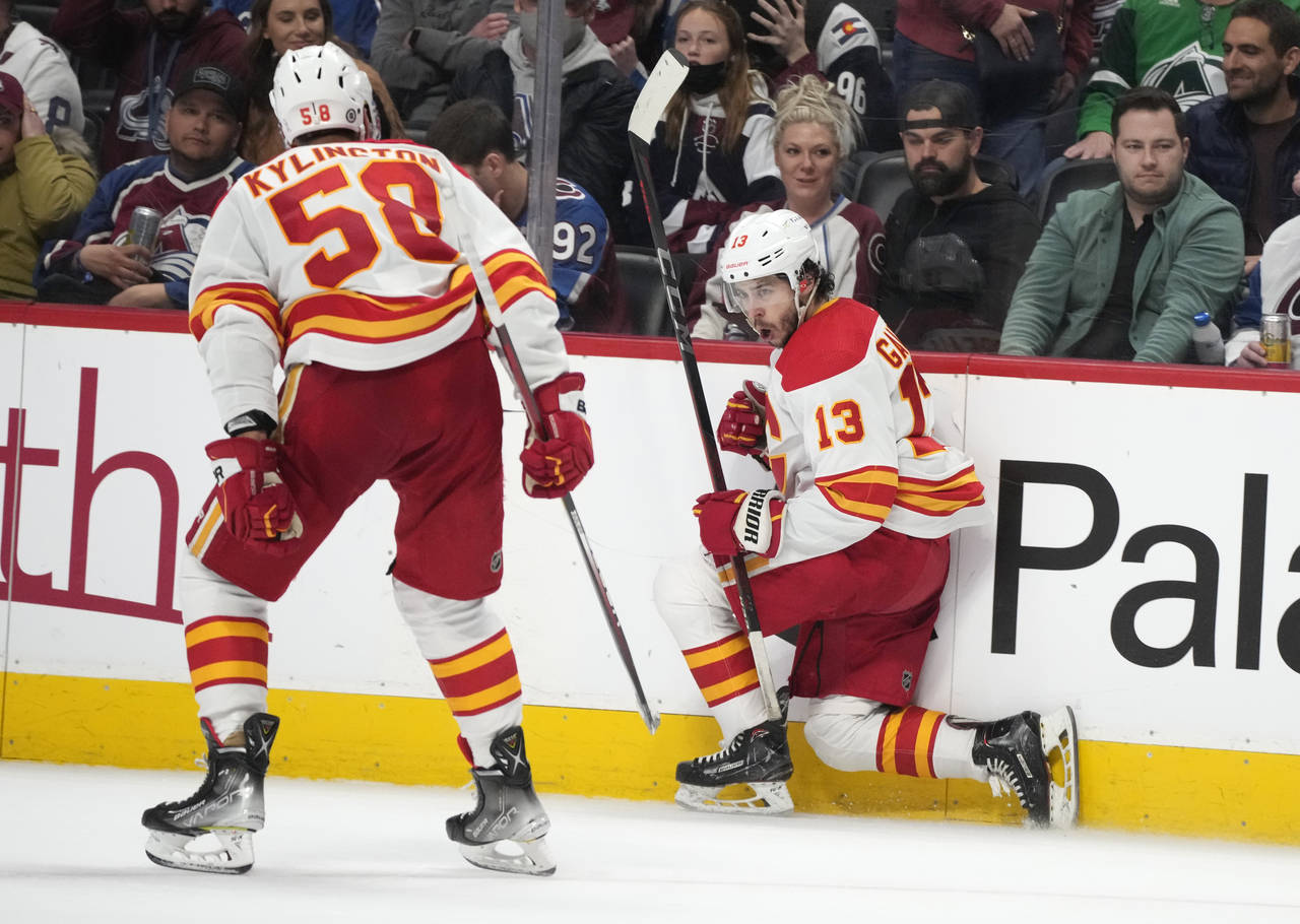 Calgary Flames left wing Johnny Gaudreau, right, celebrates his overtime goal against the Colorado ...