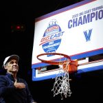 
              Villanova head coach Jay Wright gestures to supporters while cutting down the net after the final of the Big East conference tournament against Creighton, Saturday, March 12, 2022, in New York. (AP Photo/Frank Franklin II)
            