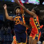 
              East girl's Ayanna Patterson blocks the shot of West girl's Flau'jae Johnson in the first half of the McDonald's All-American Girls basketball game Tuesday, March 29, 2022, in Chicago. (AP Photo/Charles Rex Arbogast)
            
