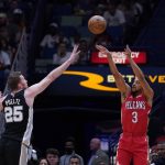 
              New Orleans Pelicans guard CJ McCollum (3) shoots against San Antonio Spurs center Jakob Poeltl (25) in the first half of an NBA basketball game in New Orleans, Saturday, March 26, 2022. (AP Photo/Gerald Herbert)
            