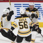 
              Boston Bruins left wing Brad Marchand (63) celebrates with teammates Jake DeBrusk, left, and Erik Haula (56) after scoring the first goal during first-period NHL hockey game action against the Montreal Canadiens in Montreal, Monday, March 21, 2022. (Ryan Remiorz/The Canadian Press via AP)
            
