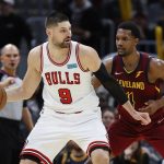 
              Chicago Bulls' Nikola Vucevic (9) is defended by Cleveland Cavaliers' Evan Mobley (4) during the second half of an NBA basketball game Saturday, March 26, 2022, in Cleveland. (AP Photo/Ron Schwane)
            
