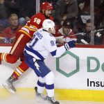 
              Tampa Bay Lightning's Steven Stamkos, right, checks Calgary Flames' Oliver Kylington during the second period of an NHL hockey game Thursday, March 10, 2022, in Calgary, Alberta. (Larry MacDougal/The Canadian Press via AP)
            