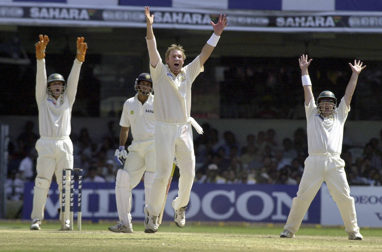 FILE - Australian bowler Shane Warne, center, celebrates after taking the wicket of India's VVS Lax...
