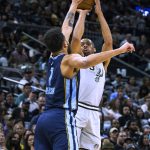 
              San Antonio Spurs forward Keldon Johnson (3) shoots over Memphis Grizzlies forward Kyle Anderson (1) during the first half of an NBA basketball game Wednesday, March 30, 2022, in San Antonio. (AP Photo/Nick Wagner)
            