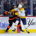 
              Philadelphia Flyers' Cam York, left, and Nashville Predators' Philippe Myers collide during the first period of an NHL hockey game, Thursday, March 17, 2022, in Philadelphia. (AP Photo/Matt Slocum)
            