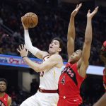 
              Cleveland Cavaliers' Cedi Osman (16) shoots against Toronto Raptors' Scottie Barnes (4) during the first half of an NBA basketball game, Sunday, March 6, 2022, in Cleveland. (AP Photo/Ron Schwane)
            