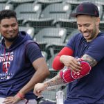 
              Minnesota Twins' Carlos Correa, right, gets ready for baseball batting practice as he talks with teammate Luis Arrez, left, at Hammond Stadium Wednesday, March 23, 2022, in Fort Myers, Fla.  (AP Photo/Steve Helber)
            