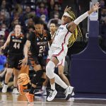
              Mercer's Shannon Titus, left, is guarded by Connecticut's Aaliyah Edwards during the first half of a first-round women's college basketball game in the NCAA tournament, Saturday, March 19, 2022, in Storrs, Conn. (AP Photo/Jessica Hill)
            