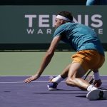 
              Grigor Dimitrov, of Bulgaria, stretches out while chasing a ball against Andrey Rublev, of Russia, at the BNP Paribas Open tennis tournament Friday, March 18, 2022, in Indian Wells, Calif. (AP Photo/Mark J. Terrill)
            