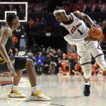 
              Illinois' Trent Frazier (1) eyes a passing outlet as Iowa's Tony Perkins defends during the first half of an NCAA college basketball game Sunday, March 6, 2022, in Champaign, Ill. (AP Photo/Michael Allio)
            