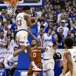 
              Kansas forward David McCormack (33) comes down with a rebound in front of Texas forward Timmy Allen (0) and Kansas' Jalen Wilson (10) during the first half of an NCAA college basketball game in Lawrence, Kan., Saturday, March 5, 2022. (AP Photo/Reed Hoffmann)
            
