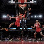 
              Houston Rockets' Christian Wood (35) and Los Angeles Clippers' Terance Mann (14) reach for a rebound during the first half of an NBA basketball game Tuesday, March 1, 2022, in Houston. (AP Photo/David J. Phillip)
            