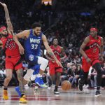 
              Minnesota Timberwolves centre Karl-Anthony Towns (32) drives around Toronto Raptors guard Gary Trent Jr. (33) as Raptors forward Precious Achiuwa (5) watches during the second half of an NBA basketball game Wednesday, March 30, 2022, in Toronto. (Nathan Denette/The Canadian Press via AP)
            