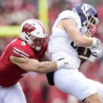 MADISON, WISCONSIN - NOVEMBER 13: Marshall Lang #88 of the Northwestern Wildcats is tackled by Leo Chenal #5 of the Wisconsin Badgers after making a catch in the first half at Camp Randall Stadium on November 13, 2021 in Madison, Wisconsin. (Photo by Patrick McDermott/Getty Images)