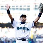 SEATTLE, WASHINGTON - APRIL 15: Ichiro Suzuki﻿ raises his arms to the stadium fans before throwing out the ceremonial first pitch prior to the Seattle Mariners' home opener against the Houston Astros at T-Mobile Park on Friday, April 15, 2022 in Seattle, Washington. Ichiro will be inducted into the Seattle Mariners Hall of Fame in August. (Photo by Steph Chambers/Getty Images)