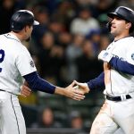 SEATTLE, WASHINGTON - APRIL 15: Tom Murphy #2 and Adam Frazier #26 of the Seattle Mariners high-five after scoring on an RBI double by Ty France #23 during the sixth inning against the Houston Astros at T-Mobile Park on April 15, 2022 in Seattle, Washington. All players are wearing the number 42 in honor of Jackie Robinson Day. (Photo by Steph Chambers/Getty Images)