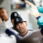 SEATTLE, WASHINGTON - APRIL 15: Adam Frazier #26 of the Seattle Mariners celebrates in the dugout after scoring on an RBI double by Ty France #23 during the sixth inning against the Houston Astros at T-Mobile Park on April 15, 2022 in Seattle, Washington. All players are wearing the number 42 in honor of Jackie Robinson Day. (Photo by Steph Chambers/Getty Images)