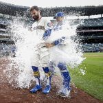 Jesse Winker #27 of the Seattle Mariners is doused with water after his RBI single to score Adam Frazier #26 to beat the Kansas City Royals 5-4 during the twelfth inning at T-Mobile Park on April 24, 2022 in Seattle, Washington. (Photo by Steph Chambers/Getty Images)