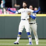 Ty France #23 celebrates with Jesse Winker #27 of the Seattle Mariners after Winker's RBI single to score Adam Frazier #26 to beat the Kansas City Royals 5-4 during the twelfth inning at T-Mobile Park on April 24, 2022 in Seattle, Washington. (Photo by Steph Chambers/Getty Images)