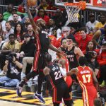 
              Miami Heat center Dewayne Dedmon dunks over teammates Jimmy Butler and Tyler Herro and Atlanta Hawks' Delon Wright and Onyeka Okongwu during the first half of Game 3 of an NBA basketball first-round Eastern Conference playoff series Friday, April 22, 2022, in Atlanta. (AP Photo/Brett Davis)
            