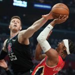 
              New Orleans Pelicans guard Devonte' Graham, right, shoots as Los Angeles Clippers center Isaiah Hartenstein defends during the first half of an NBA basketball play-in tournament game Friday, April 15, 2022, in Los Angeles. (AP Photo/Mark J. Terrill)
            