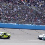 
              Ryan Blaney (12) leads Chase Elliott (9) at the halfway point of a NASCAR Cup Series auto race at Phoenix Raceway, Sunday, March 13, 2022, in Avondale, Ariz. (AP Photo/Darryl Webb)
            