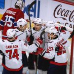 
              Washington Capitals right wing Garnet Hathaway, center, celebrates his goal against Montreal Canadiens goaltender Sam Montembeault (35) with teammates during the third period of an NHL hockey game Saturday, April 16, 2022, in Montreal. (Peter McCabe/The Canadian Press via AP)
            