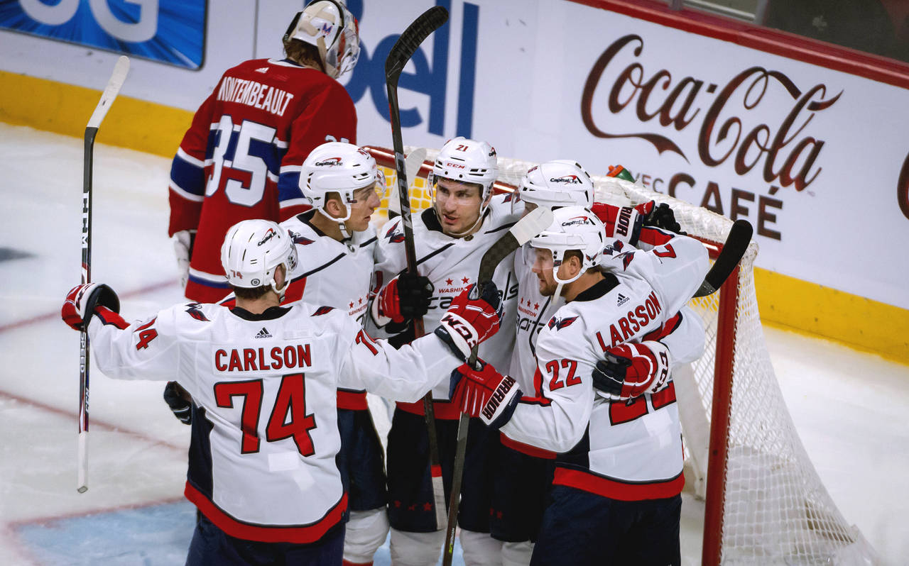 Washington Capitals right wing Garnet Hathaway, center, celebrates his goal against Montreal Canadi...