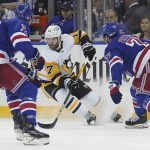 
              Pittsburgh Penguins right wing Bryan Rust (17) breaks against the New York Rangers defense during the third period of NHL hockey game Thursday, April 7, 2022, in New York. (AP Photo/Bebeto Matthews)
            